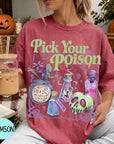 A woman wearing a red t-shirt with a Halloween-themed graphic and text, holding a drink in a glass.