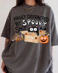 A person wearing a gray t-shirt with a humorous Halloween-themed graphic design.