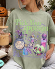 A woman wearing a green t-shirt with a Halloween-themed graphic and text, holding a drink in a glass.