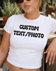 A woman wearing a white t-shirt with the text "CUSTOM TEXT/PHOTO" printed on it.