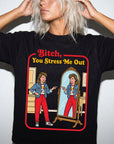 A woman wearing a black t-shirt with a graphic design depicting two women in a mirror, one of whom is pointing at the other.