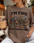 A person wearing a t-shirt with a humorous text and a graphic design, sitting in a cozy setting with a pumpkin and other fall decorations in the background.