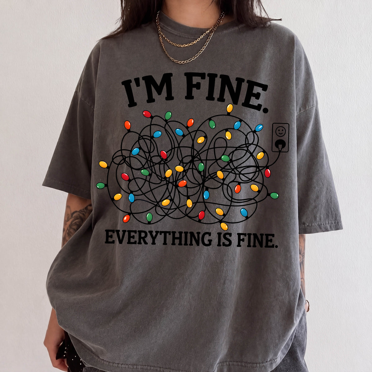 A person wearing a gray t-shirt with a graphic design that says "I'm fine. Everything is fine."