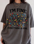 A person wearing a gray t-shirt with a graphic design that says "I'm fine. Everything is fine."