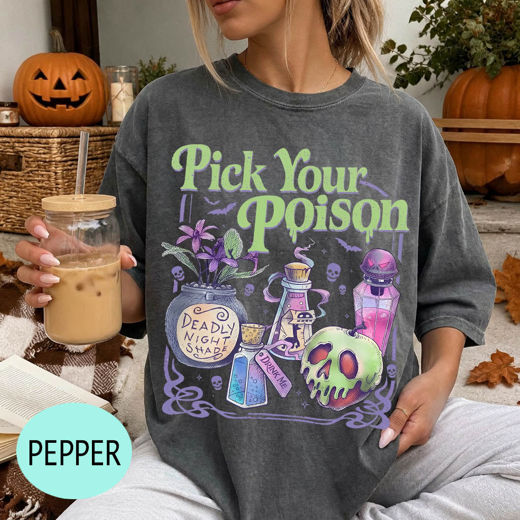 A woman wearing a t-shirt with a Halloween-themed graphic and holding a drink, with a pumpkin and other Halloween decorations visible in the background.