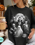 A woman wearing a black t-shirt with a graphic design featuring characters from the horror film "The Exorcist" and Halloween decorations.