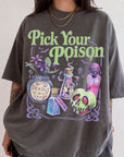 A person wearing a gray t-shirt with a graphic design featuring various Halloween-themed items such as a skull, a vase, and a bottle of poison.