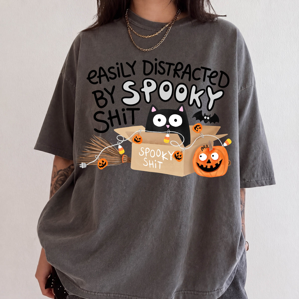 A person wearing a gray t-shirt with a humorous Halloween-themed graphic design.