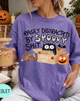 A person wearing a purple t-shirt with a humorous Halloween-themed graphic, including a cat, pumpkins, bats, and the text "EASILY DISTracted BY SPOOKY SHIT".