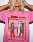A woman wearing a pink t-shirt with a graphic design depicting a woman looking into a mirror and reading the text "Bitch, You Stress Me Out".