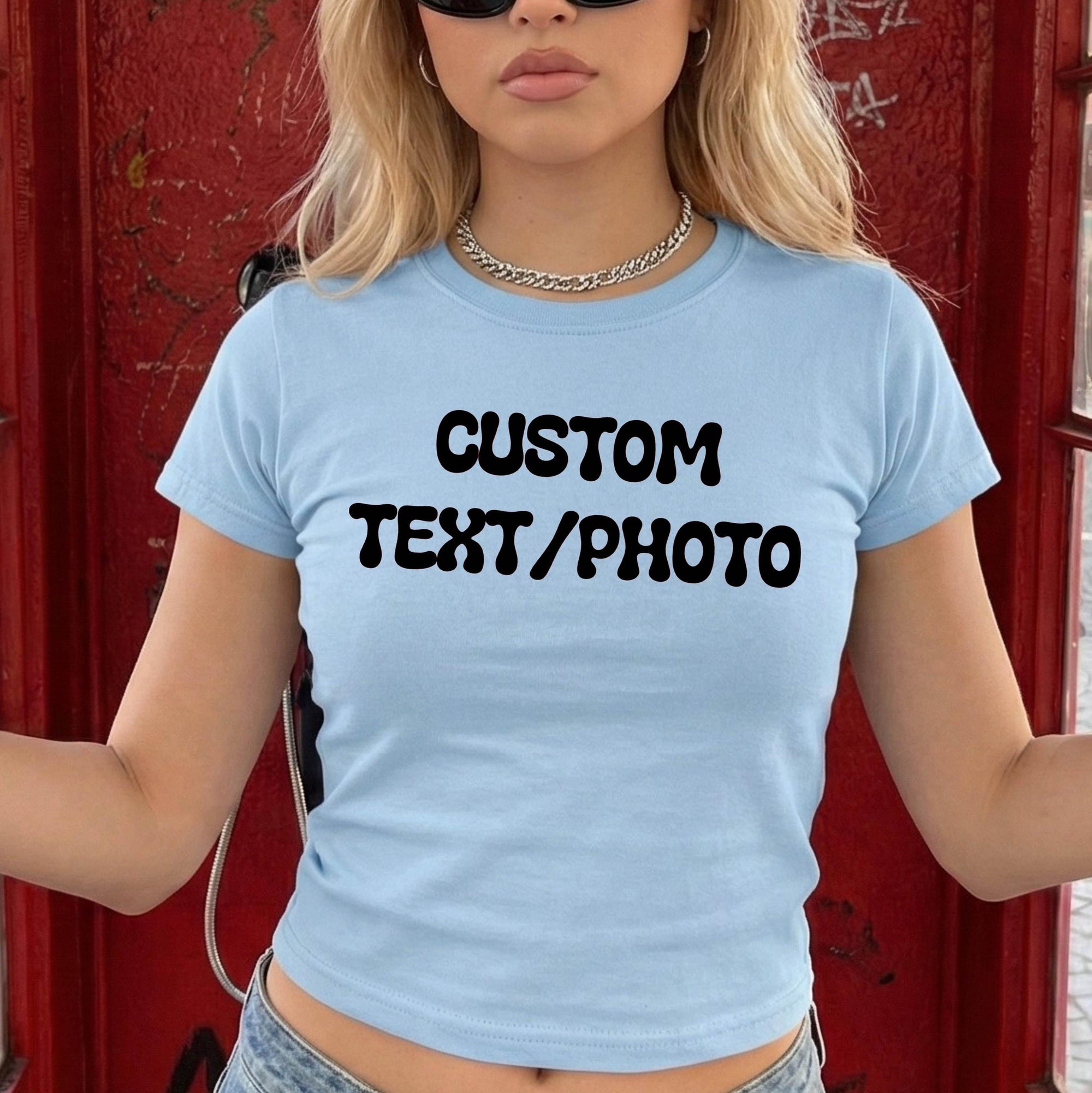 A woman wearing a light blue t-shirt with the text &amp;quot;CUSTOM TEXT/PHOTO&amp;quot; printed on it.