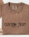 a brown t-shirt with the text "CUSTOM TEXT" printed on it, along with the word "OPTIONAL LINE". The t-shirt is displayed on a white background, accompanied by a hat, a necklace, and some flowers. The word "ESPRESSO" is also visible in the image.